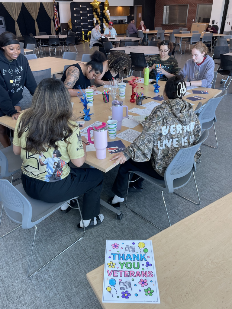 Students sitting at a table during the veterans resource display in the cafe